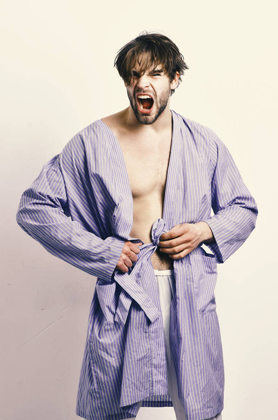 Fashion Model. Man with beard in blue dressing gown on grey background. - Фото, зображення