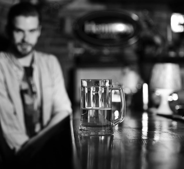 glass of beer. Glass of draft beer on blurred bar background. - Φωτογραφία, εικόνα