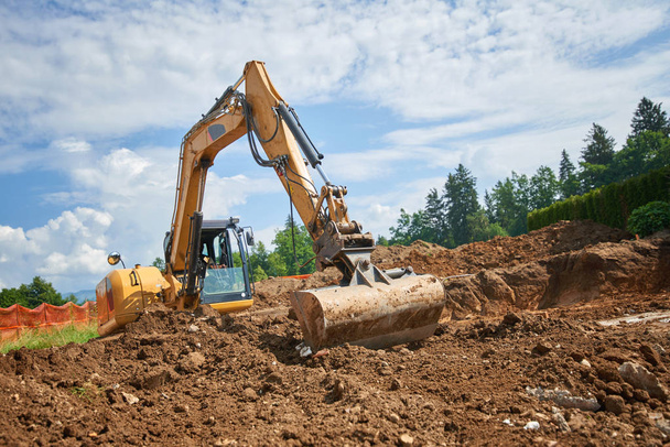 Spychacz w Otwórz pole operationexcavator o budowie - kopanie fundamentów dla domu - Zdjęcie, obraz