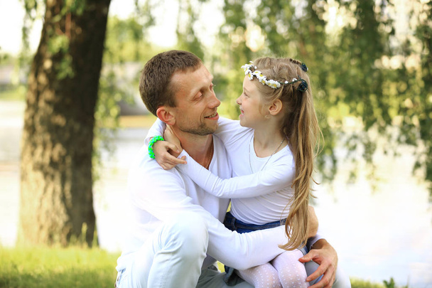 concept of fatherhood - happy father and little daughter hugging - Фото, зображення