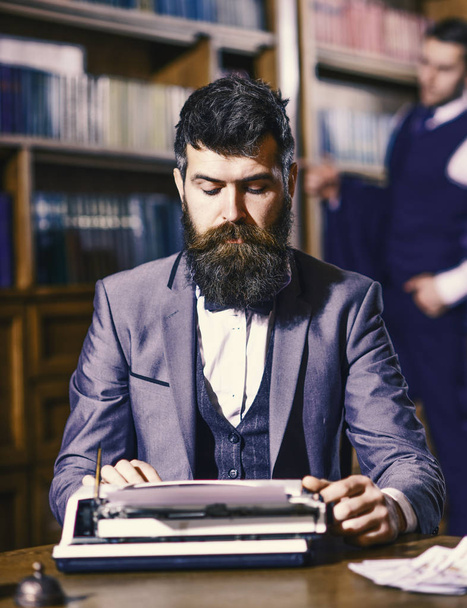 writer at work. Man with beard and busy face sit in library - Foto, immagini