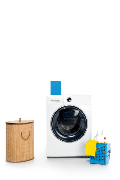 blank box with detergent on washing machine, cleaning supplies and laundry basket isolated on white  - Photo, Image