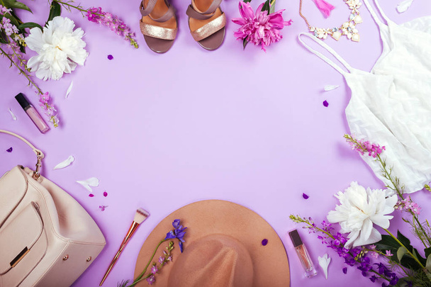 Summer female outfit. Set of clothes, shoes, cosmetics and accessories with fresh flowers. Beauty fashion concept. Trendy jewellery. Copy space - Photo, Image