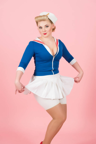 Young sailor girl in pin-up style with white skirt. Anime styled blonde woman on pink background - Φωτογραφία, εικόνα