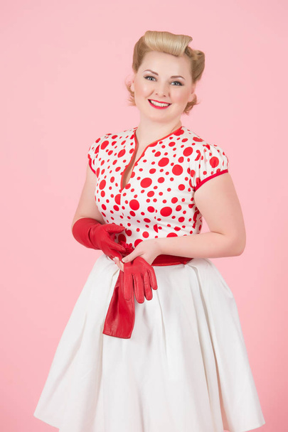 Girls happiness blonde with red long gloves on pastel pink background. Pretty curls woman with pin-up make-up isolated in studio. - Foto, imagen
