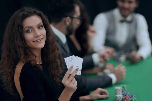 beautiful woman showing a combination of four aces. - Фото, изображение