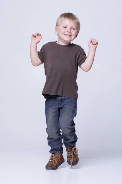 Studio portrait of a cute smiling boy in studio. Happy child. - Foto, Bild