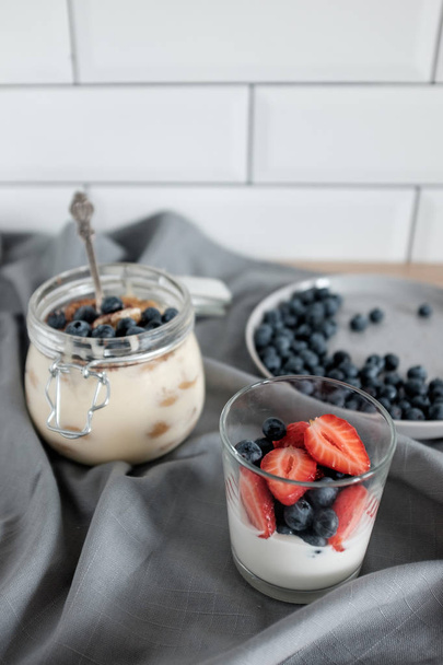 A healthy dessert  tiramisu with blueberries and strawberries. Dessert in a glass - Foto, imagen