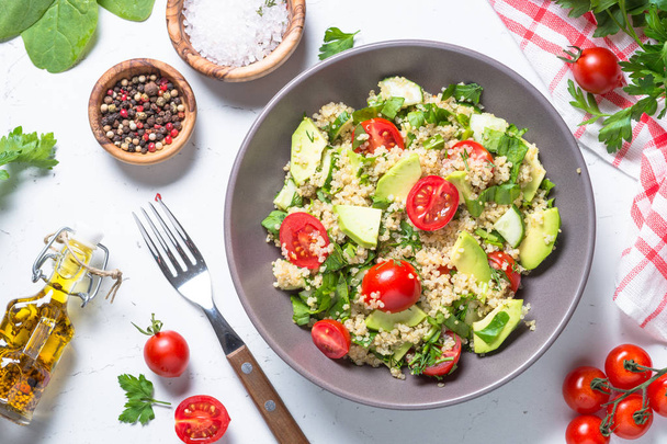 Quinoa salad with spinach, avocado and tomatoes top view. - Photo, Image