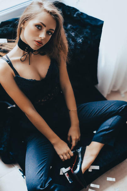 Beautiful young woman posing in fashion clothes in studio  - Foto, immagini