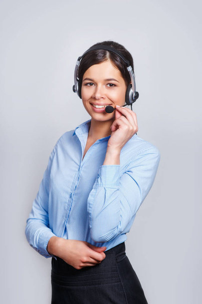 customer support phone operator in headset, with blank copyspace area for slogan or text message, over grey background. Consulting and assistance service call center. - Fotó, kép