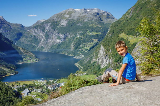 Boy hiking to Seven Sisters Waterfall in Geirangerfjord. Norway - Fotó, kép