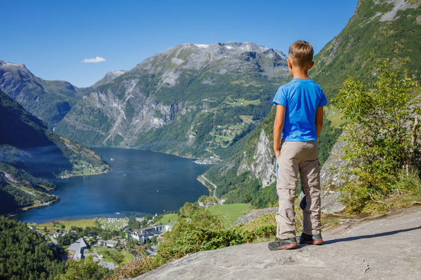 Boy hiking to Seven Sisters Waterfall in Geirangerfjord. Norway - Fotó, kép