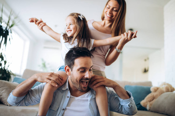 Happy family having fun time together at home - Фото, изображение