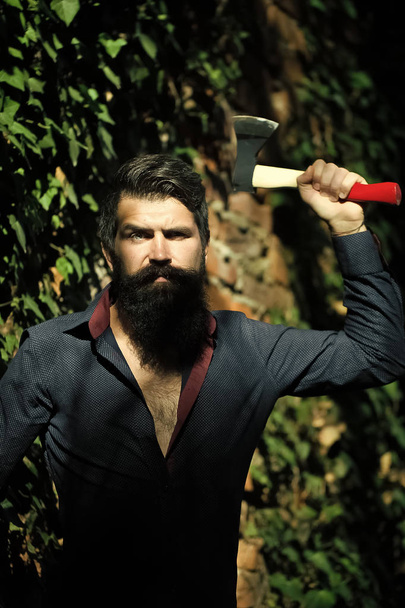 Brutal man with axe. Man with axe outdoor - Foto, afbeelding