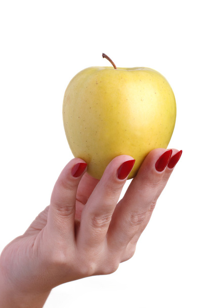 Žluté jablko v rukou ženy - Fotografie, Obrázek