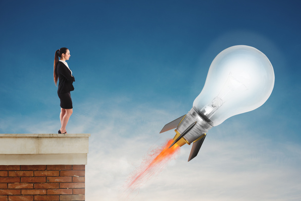 Fast lightbulb as a rocket ready to fly fast. Concept of new super idea - Photo, Image