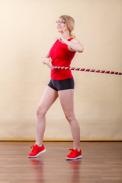 Fitness, sport, training and healthy lifestyle. Young woman in full length doing exercise with hula hoop, girl having fun playing game hula-hoop - Photo, Image