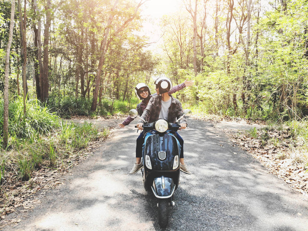 Couple riding their scooter through forest. life style idea concept - Foto, Imagem