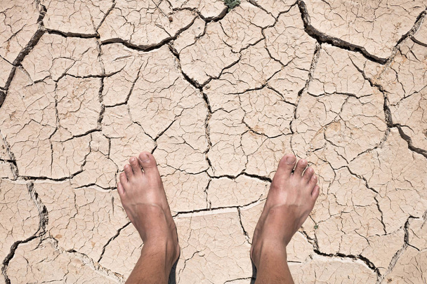 Crack dry ground on foot, drought concept. - Photo, Image