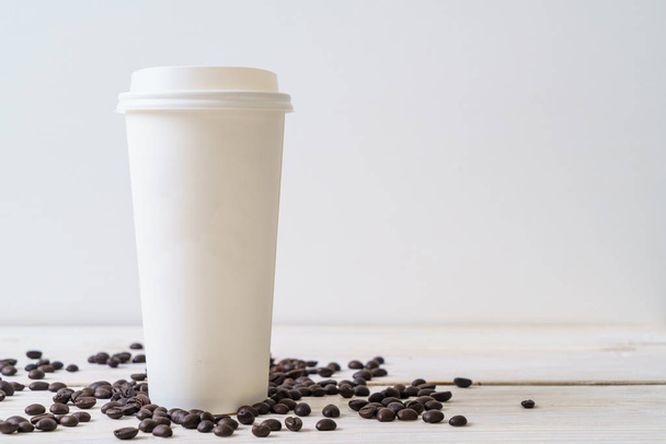 Paper cup of takeaway coffee on wood background - Fotografie, Obrázek