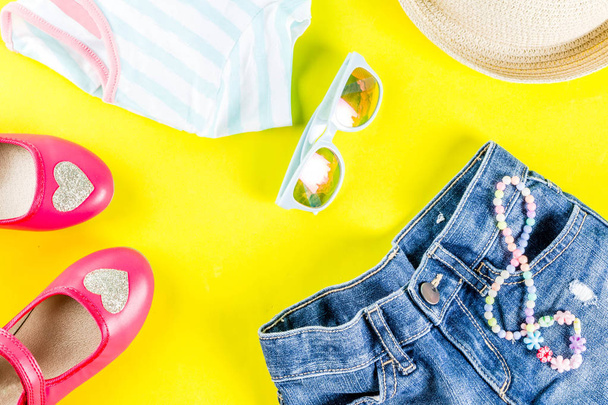 Летние каникулы концепция, набор ткани для летнего ребенка - детские шорты, футболки, шляпа, солнцезащитные очки, браслет ожерелье, кроссовки, ярко-желтый фон над плоским копировать пространство
 - Фото, изображение
