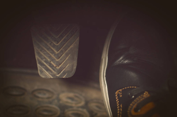 Driver foot on gas pedal of car close up photo. Car travel concept. - Foto, imagen