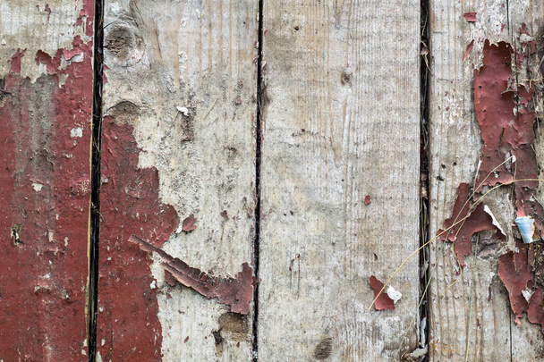 Old wooden background with remains of pieces of scraps of old paint on wood. - Фото, зображення