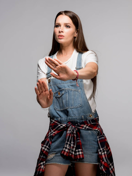 Young brunette woman gesturing with hands showing stop sign - Φωτογραφία, εικόνα