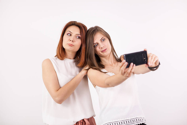 Two happy girls taking a selfie - Fotografie, Obrázek