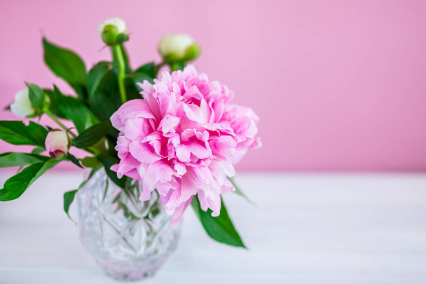 Pink peonies in vase on wood background - Photo, image