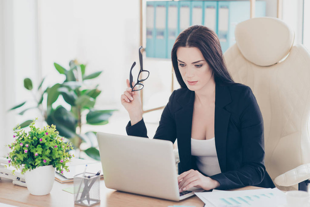 Portrait of professional confident user attractive mature lawyer having glasses in hand checking email working on project, start up, presentation, sitting at desk in modern workplace - Foto, immagini