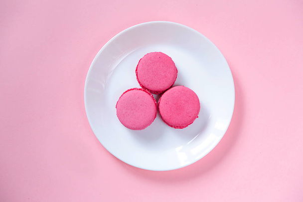 Some sweet french biscuits on the pink paper background. Top view. - Zdjęcie, obraz
