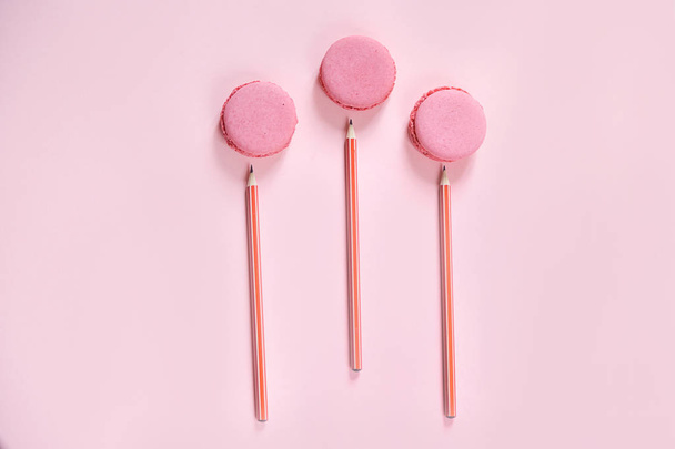Some sweet french biscuits on the pink paper background. Top view. - Photo, image