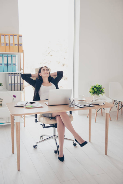 Full size portrait of sexy trendy woman wearing high heel shoes skirt sitting in modern office holding hands behind head planning vacation weekend trip journey - Φωτογραφία, εικόνα