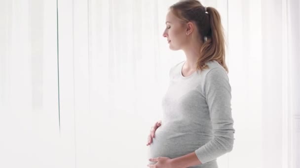 Portrait of happy pregnant woman at home - Footage, Video