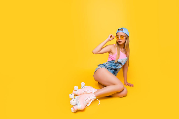 Portrait with copyspace empty place of naughty sensual girl holding eyelet of glasses on face looking away having booty bum isolated on yellow background, workout fitness body care concept - Φωτογραφία, εικόνα
