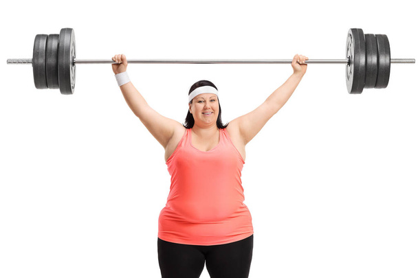 Overweight woman working out with a barbell isolated on white background - Fotografie, Obrázek