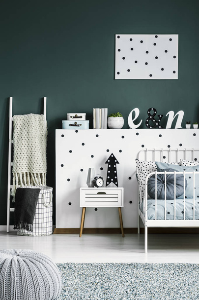 Polka dot poster on a dark green wall in a scandinavian style white bedroom interior for a teenager - Photo, Image
