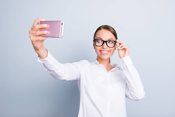 Portrait of fashionable style stylish trendy lovely cute sweet tender gentle feminine with beaming toothy shiny smile manager taking selfie on modern smartphone isolated on gray background copy-space - Valokuva, kuva