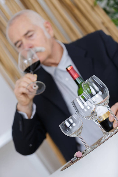 senior man enjoys drinking wine - 写真・画像
