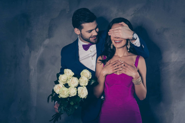 Portrait of excited lady in purple dress creative gentlemen in tux with bowtie prepare surprise gor lover, lovely romantic spuses isolated on grey background. 14-february 8-march concept - Foto, immagini