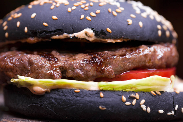 Gourmet black burger with Spicy sauce - Photo, Image