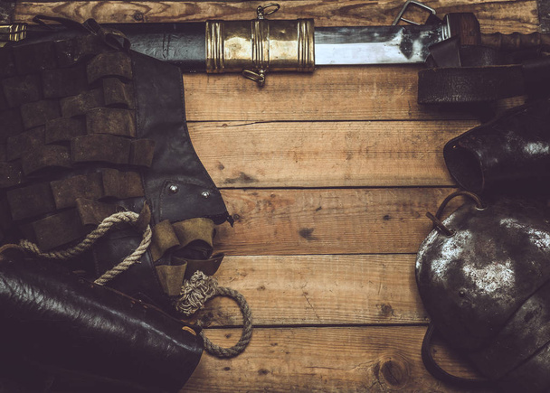 Complete combat equipment of the ancient Greek warrior on a wooden boards background. - Foto, Bild