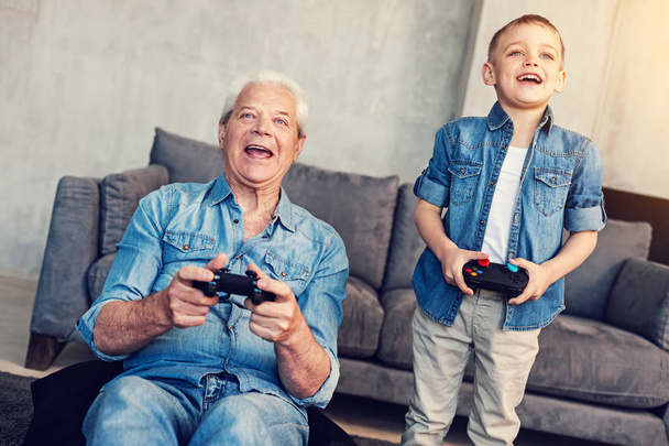 Emotional men of different age playing games - Foto, afbeelding