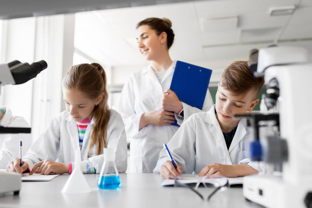 teacher and students studying chemistry at school - Фото, зображення