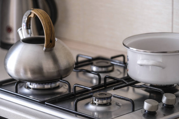 The image of a gas stove close up with kettle and pan - Фото, зображення