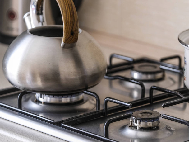 The image of a gas stove close up with kettle and pan - Φωτογραφία, εικόνα