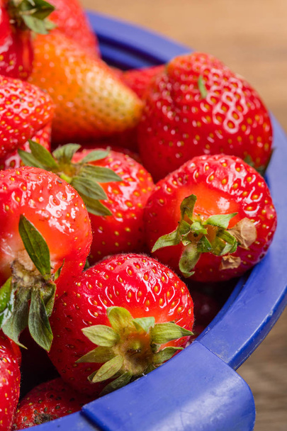 Fresh strawberries from a home garden in a colander. - Zdjęcie, obraz
