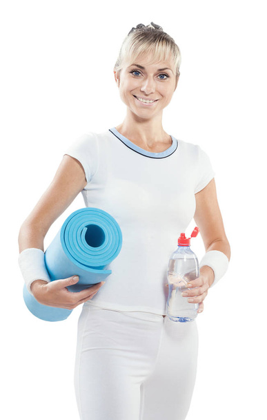beautiful smiling  sports woman holding bottle of water and yoga - Zdjęcie, obraz